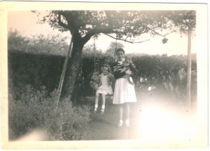 Hazel on the swing with sister Brenda Bromage (nee Wallis) in the garden                    